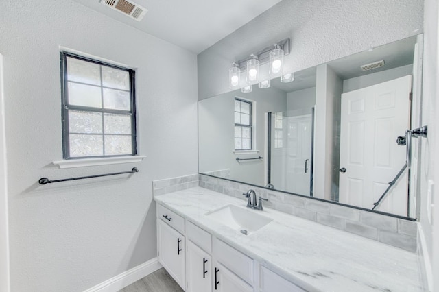 bathroom featuring vanity and walk in shower