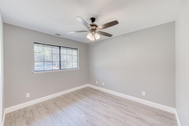 empty room featuring ceiling fan and light wood-type flooring