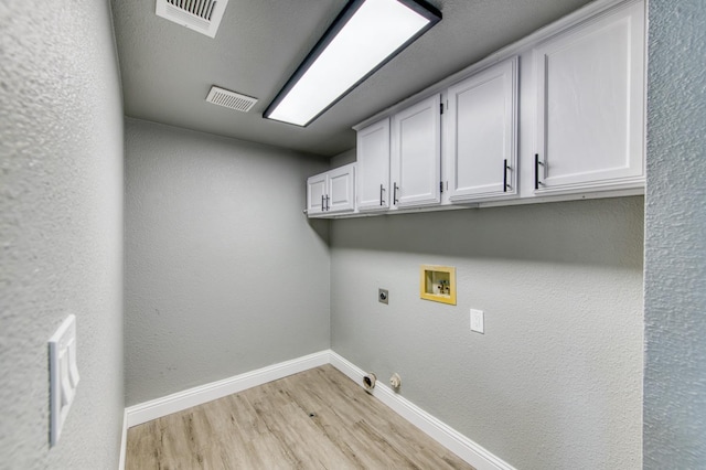 laundry room with cabinets, hookup for a washing machine, hookup for an electric dryer, hookup for a gas dryer, and light hardwood / wood-style floors