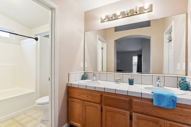 full bathroom featuring vanity, shower / washtub combination, and toilet