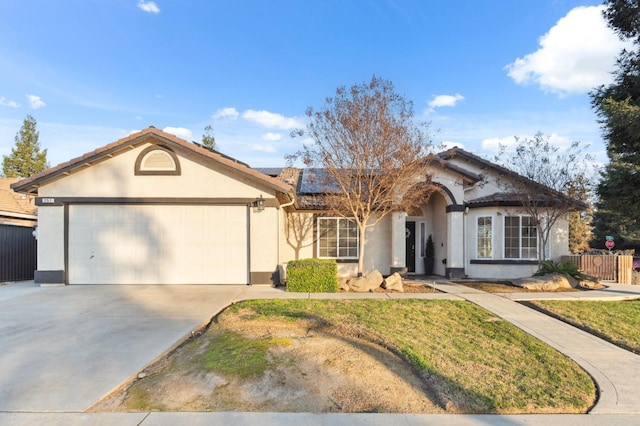 ranch-style house featuring a garage and solar panels