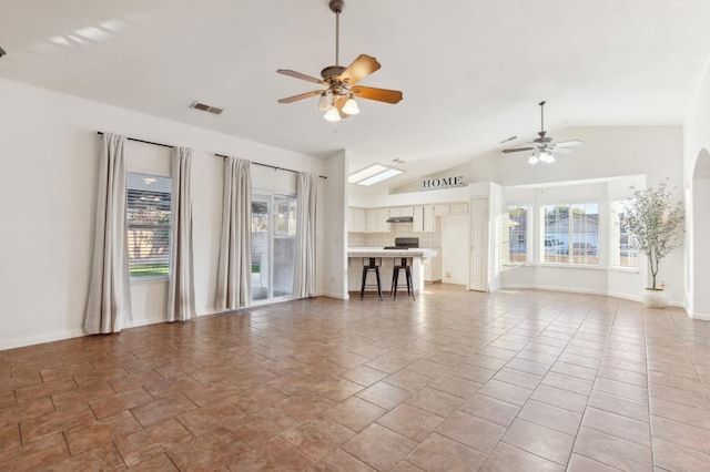 unfurnished living room featuring lofted ceiling and ceiling fan