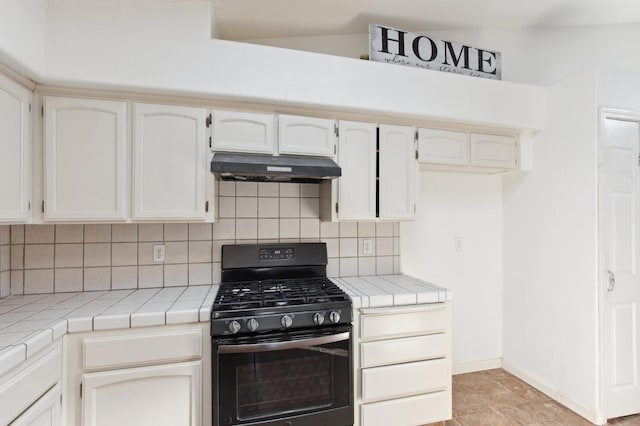 kitchen with black range with gas cooktop, white cabinetry, tile countertops, and decorative backsplash