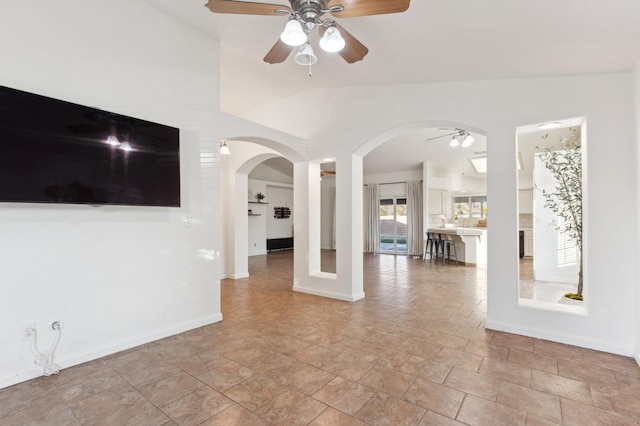 unfurnished living room with vaulted ceiling and ceiling fan