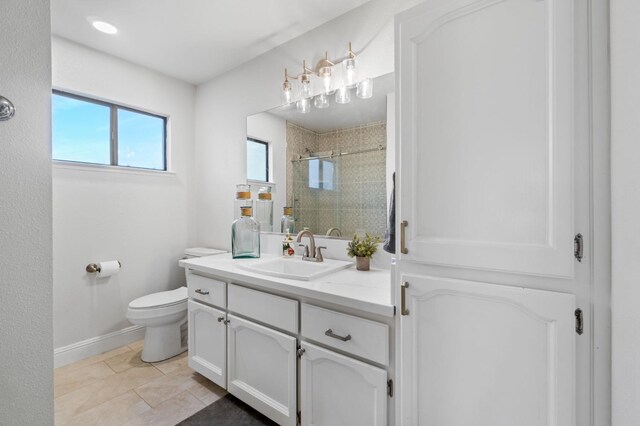 bathroom with tile patterned flooring, vanity, toilet, and a shower with shower door