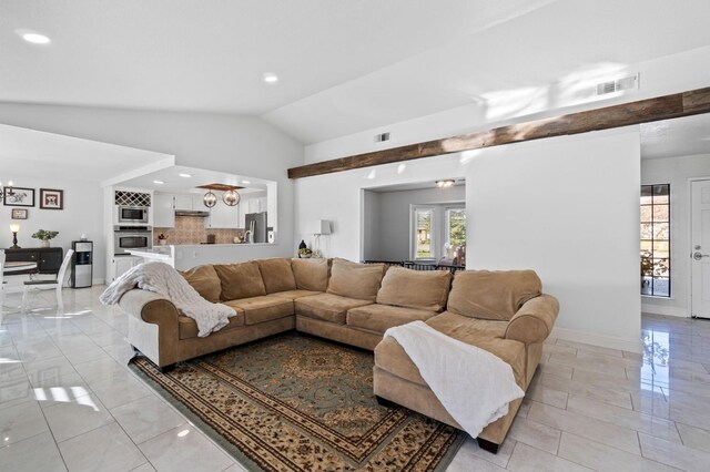 living room featuring vaulted ceiling and a healthy amount of sunlight