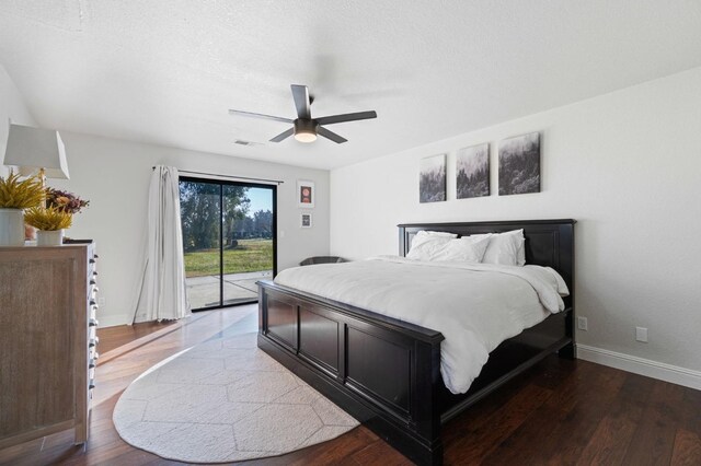 bedroom with access to outside, dark hardwood / wood-style floors, and ceiling fan