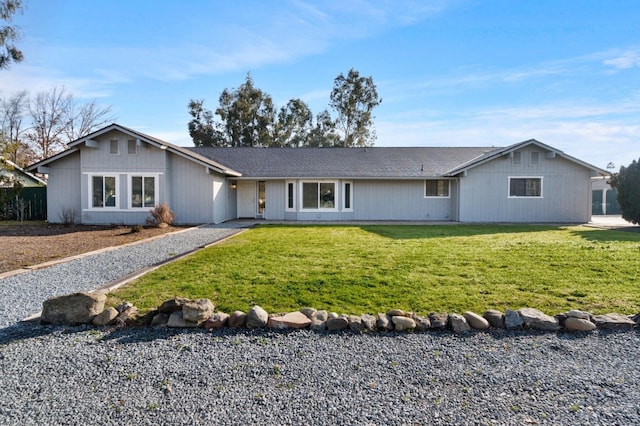 single story home featuring a front lawn