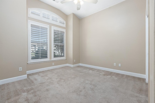 carpeted spare room featuring lofted ceiling and ceiling fan