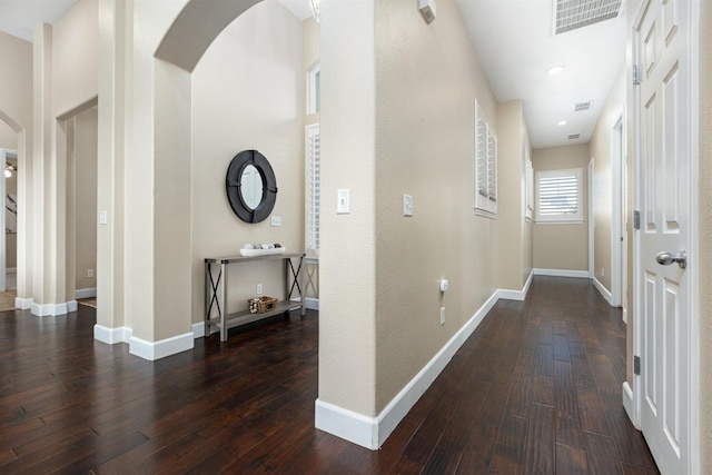 corridor with dark hardwood / wood-style flooring