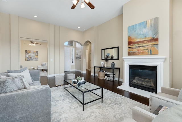 living room with dark hardwood / wood-style floors and ceiling fan