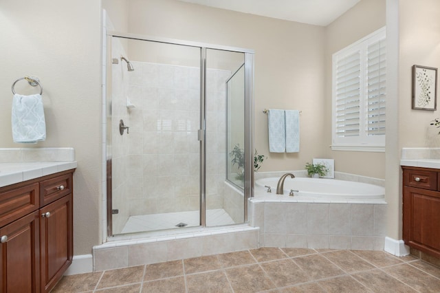 bathroom featuring vanity, tile patterned flooring, and plus walk in shower