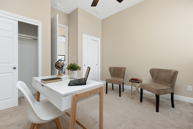 carpeted home office featuring ceiling fan