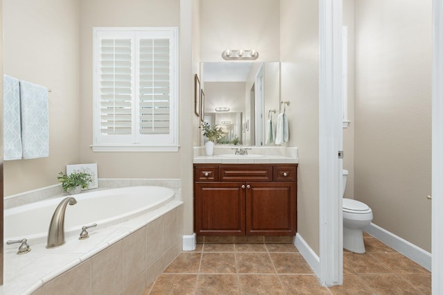 bathroom with tile patterned flooring, vanity, tiled bath, and toilet