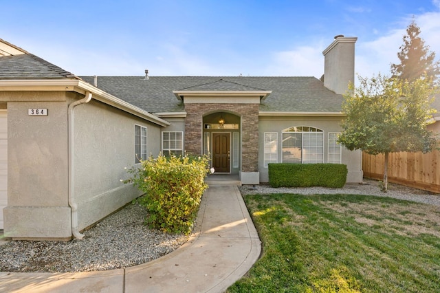 entrance to property featuring a lawn