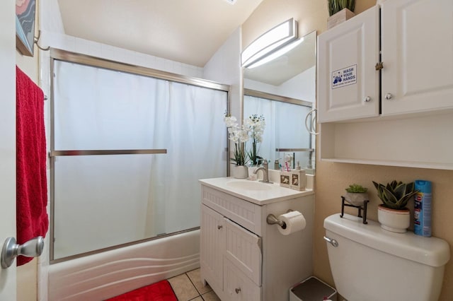 full bathroom featuring tile patterned floors, toilet, combined bath / shower with glass door, and vanity