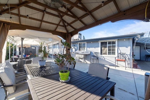 view of patio / terrace with a gazebo, ceiling fan, and exterior bar