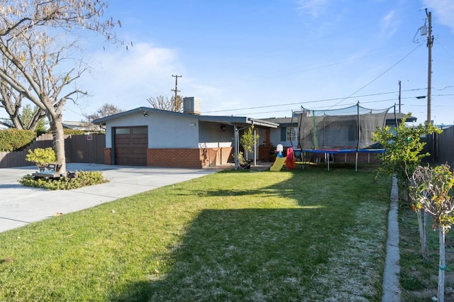 view of front of home with a front lawn and a trampoline