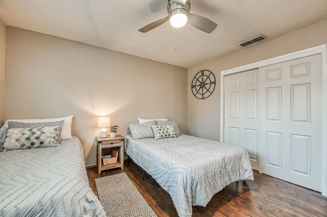 bedroom featuring visible vents, a ceiling fan, wood finished floors, a textured ceiling, and a closet