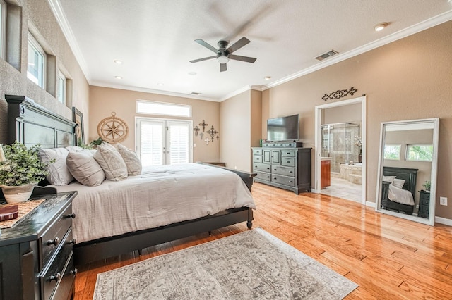 bedroom featuring baseboards, light wood-style floors, visible vents, and crown molding