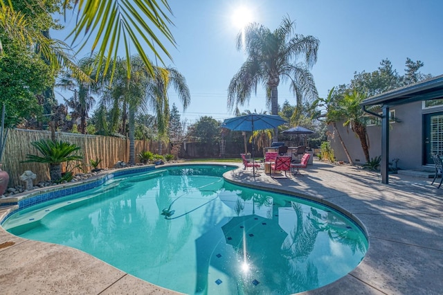 view of swimming pool featuring a fenced backyard, a fenced in pool, and a patio