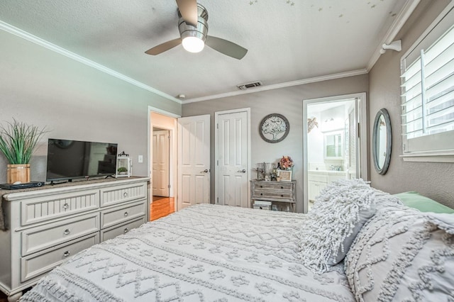 bedroom featuring visible vents, a ceiling fan, ornamental molding, ensuite bathroom, and a textured ceiling