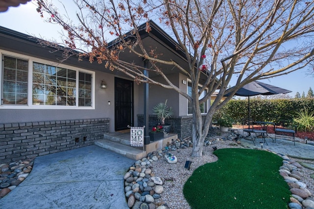 view of front of home featuring a patio and stucco siding