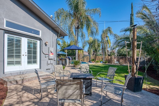 view of patio with french doors and a fenced backyard