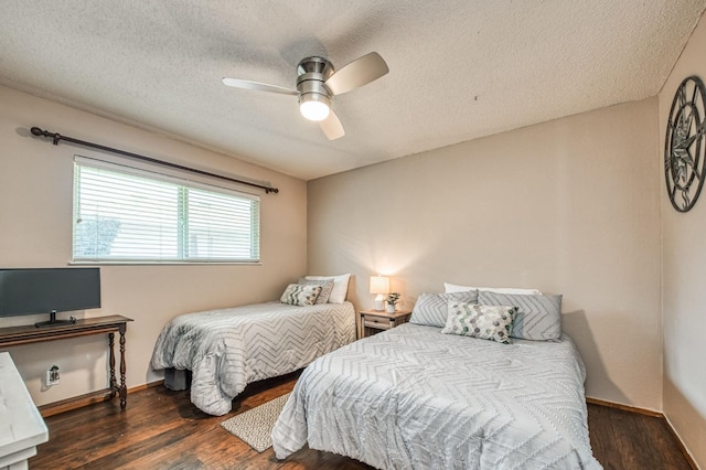 bedroom featuring a ceiling fan, a textured ceiling, baseboards, and wood finished floors