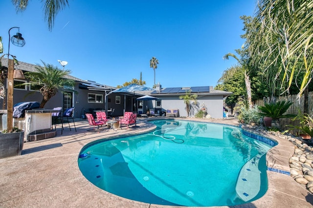 view of pool with a patio area, fence, outdoor dry bar, and a fenced in pool