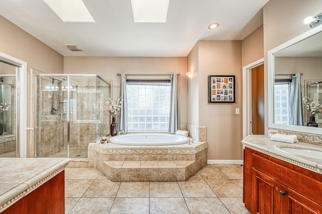 full bathroom with a skylight, visible vents, a stall shower, and vanity