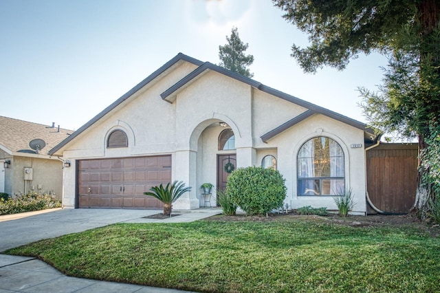 view of front of home with a garage, concrete driveway, a front lawn, and stucco siding