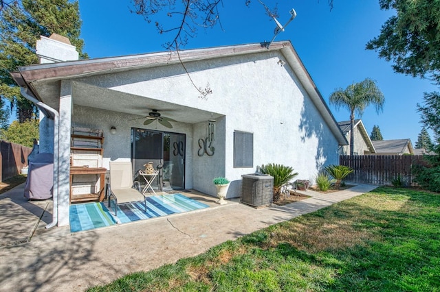 back of house featuring a patio area, fence, a ceiling fan, and stucco siding