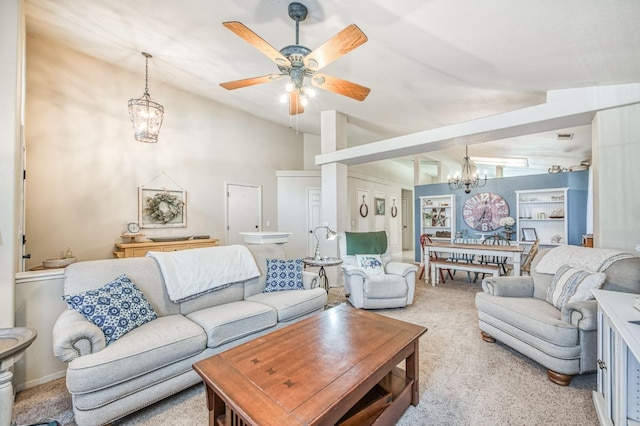 living area with lofted ceiling, carpet flooring, and ceiling fan with notable chandelier