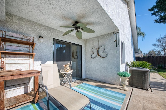 view of patio / terrace featuring central AC, fence, and a ceiling fan