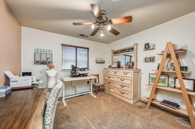 office with visible vents, a ceiling fan, and light colored carpet