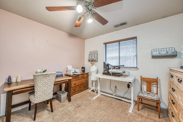 home office featuring light carpet, visible vents, and a ceiling fan