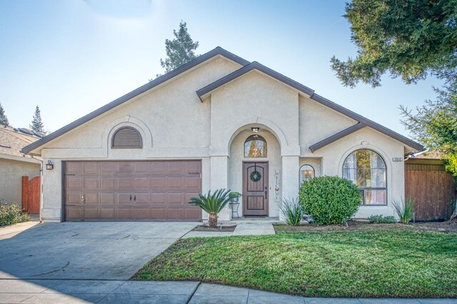 view of front of house with a garage and a front lawn