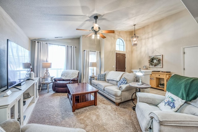 living room featuring light carpet, plenty of natural light, and a textured ceiling