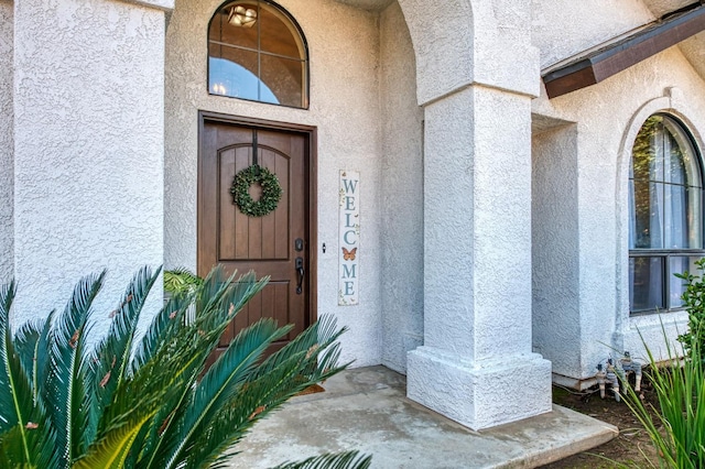 entrance to property with stucco siding