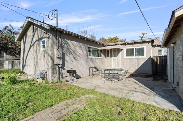 back of house featuring a yard and a patio area