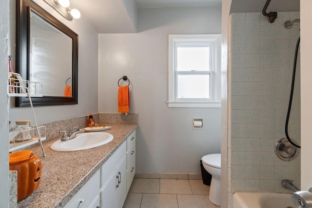 full bathroom with vanity, tiled shower / bath, tile patterned floors, and toilet