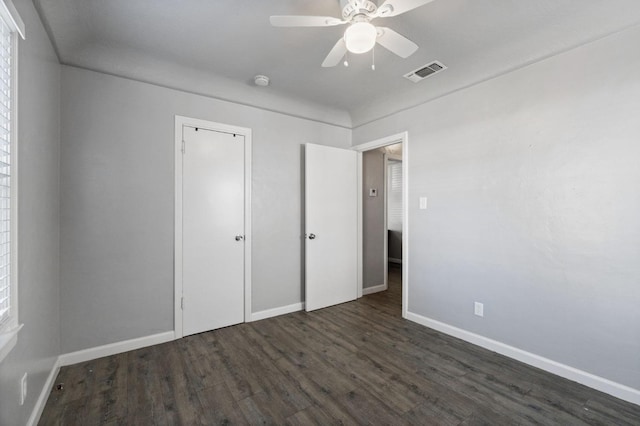 unfurnished bedroom featuring dark hardwood / wood-style floors and ceiling fan