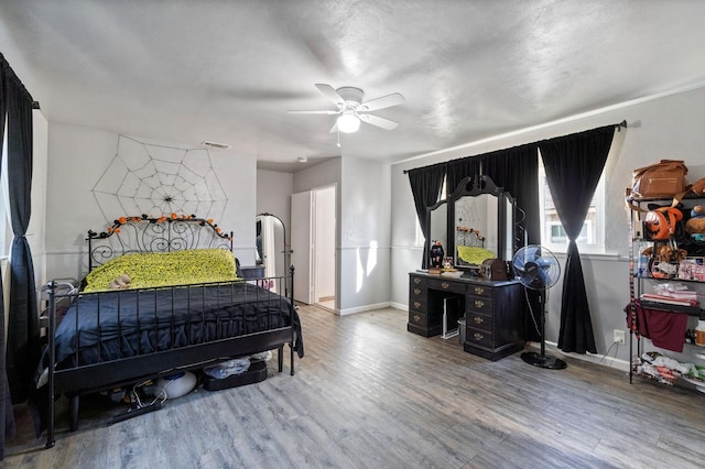 bedroom with hardwood / wood-style flooring and ceiling fan