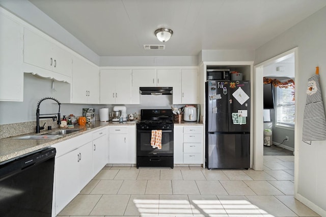 kitchen with white cabinetry, sink, light tile patterned floors, and black appliances