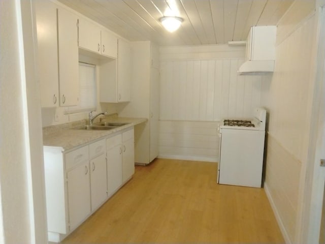 kitchen with sink, wood ceiling, white range with gas stovetop, white cabinetry, and light hardwood / wood-style floors