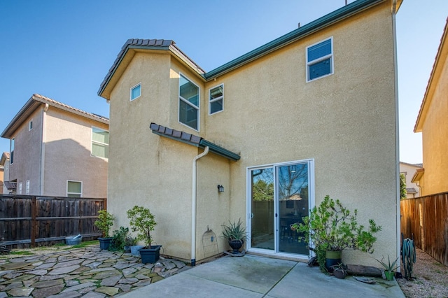 back of property featuring a patio area