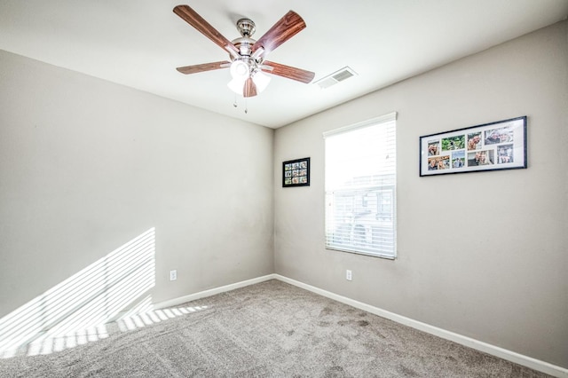 carpeted spare room featuring ceiling fan