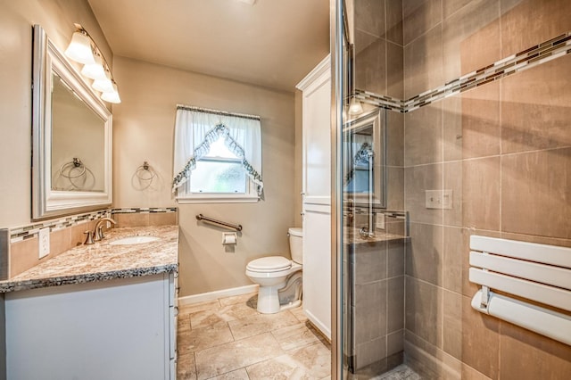 bathroom featuring vanity, toilet, and an enclosed shower