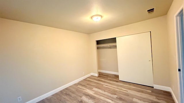 1859 S Karen Ave, Fresno, CA 93727 - unfurnished bedroom with light wood-style floors, baseboards, and a closet